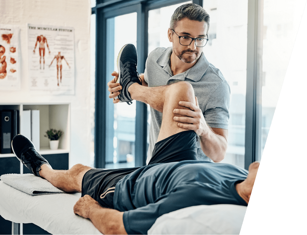 Physical therapist performing knee range of motion evaluation on a patient during ACL reconstruction rehabilitation under Dr. Merritt's care